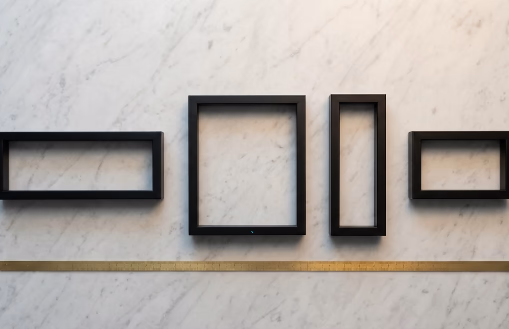 Four picture frames in different aspect ratios on a marble surface