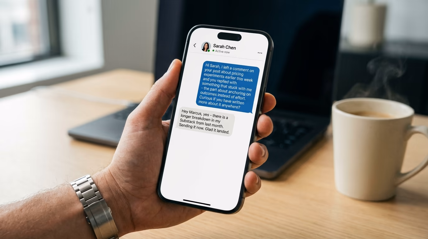 Hand holding a phone showing a LinkedIn conversation thread with a personalized outreach reply