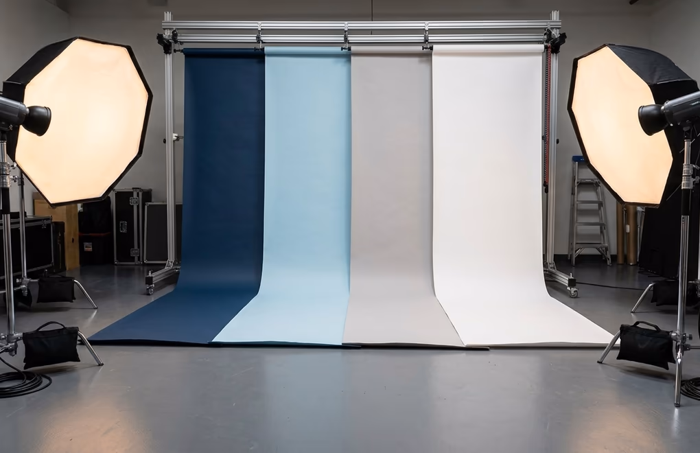 Color palette samples in blue, gray, and white tones on a studio wall