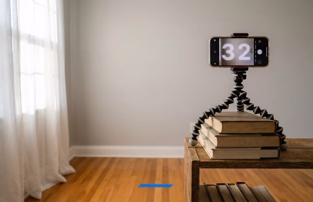Smartphone on tripod in front of window with natural light for headshot